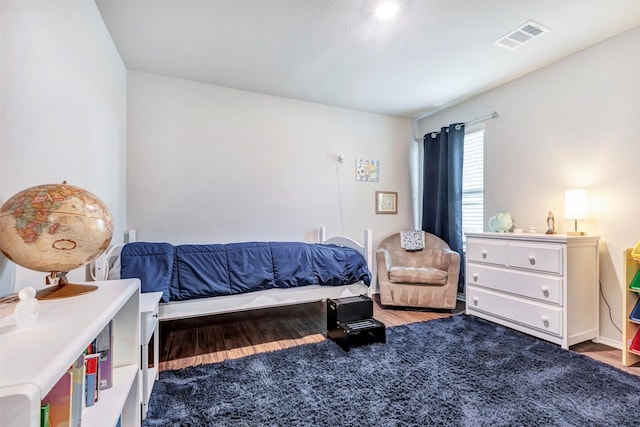 bedroom with wood finished floors and visible vents