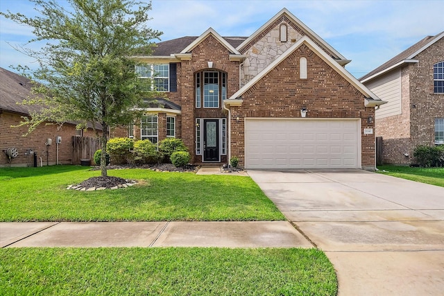 traditional-style house featuring a garage, brick siding, fence, a front lawn, and concrete driveway