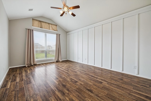 spare room featuring ceiling fan, baseboards, vaulted ceiling, dark wood-type flooring, and visible vents