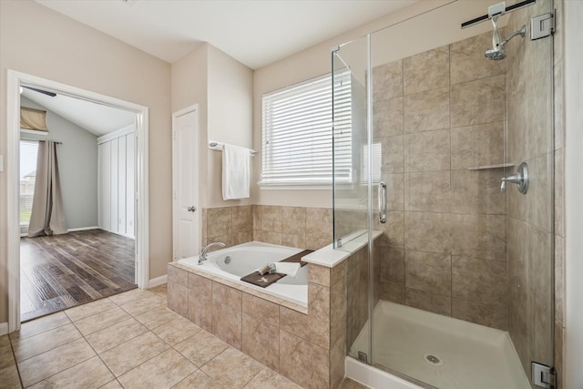 bathroom with tile patterned floors, a shower stall, and a garden tub