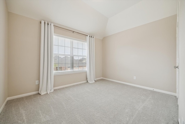 empty room with baseboards, carpet, and lofted ceiling