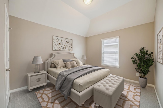 bedroom featuring baseboards, carpet, and lofted ceiling