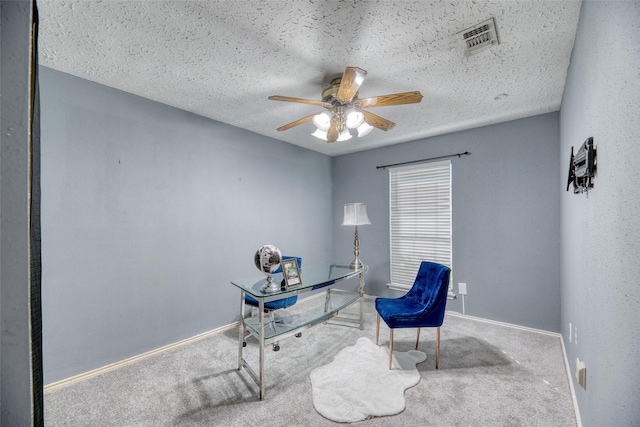 home office featuring carpet floors, baseboards, a ceiling fan, and visible vents