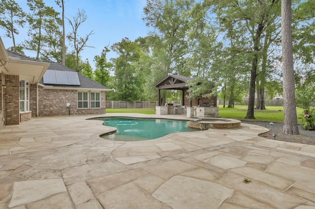 view of swimming pool featuring a gazebo, a pool with connected hot tub, a fenced backyard, a patio, and a yard