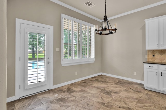 unfurnished dining area with crown molding, baseboards, visible vents, and an inviting chandelier