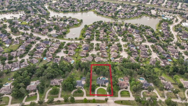 birds eye view of property featuring a water view and a residential view