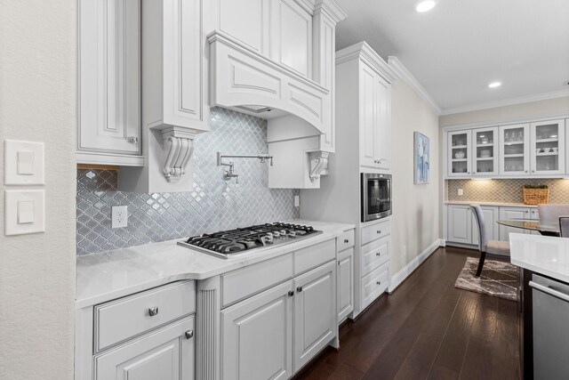 kitchen featuring white cabinetry, appliances with stainless steel finishes, and tasteful backsplash