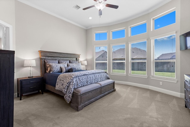 bedroom with a ceiling fan, visible vents, baseboards, ornamental molding, and carpet flooring