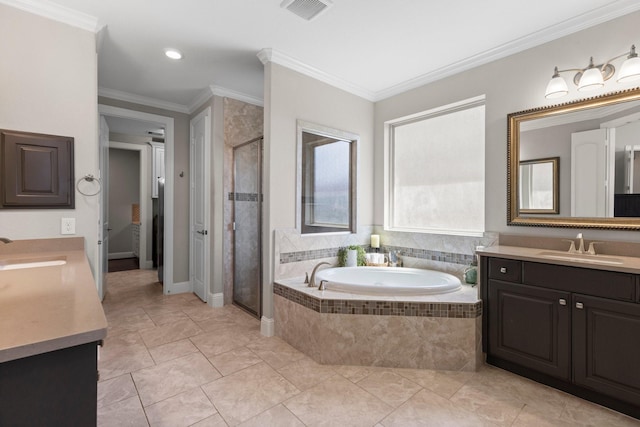 bathroom with vanity, a stall shower, a bath, and visible vents