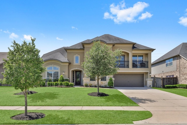 view of front of home with an attached garage, a front lawn, stucco siding, a balcony, and driveway