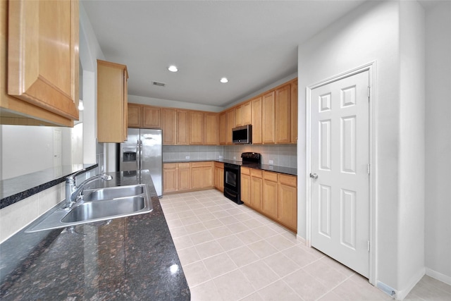 kitchen with decorative backsplash, visible vents, appliances with stainless steel finishes, a sink, and light tile patterned flooring