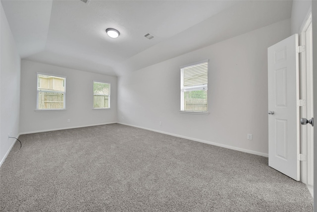 carpeted empty room with visible vents and baseboards