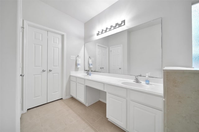 bathroom with double vanity, tile patterned floors, and a sink