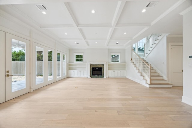 unfurnished living room featuring light wood-style floors, coffered ceiling, beamed ceiling, recessed lighting, and stairway