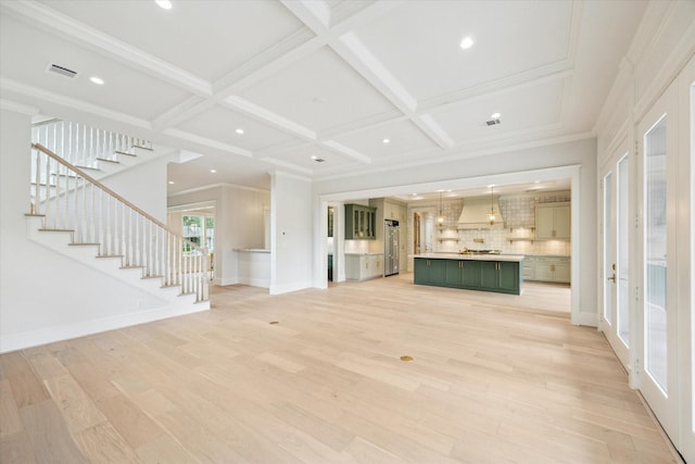 unfurnished living room featuring light wood finished floors, stairway, coffered ceiling, beamed ceiling, and baseboards