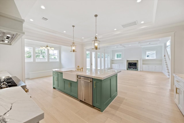 kitchen featuring green cabinetry, dishwasher, a sink, light wood finished floors, and a chandelier