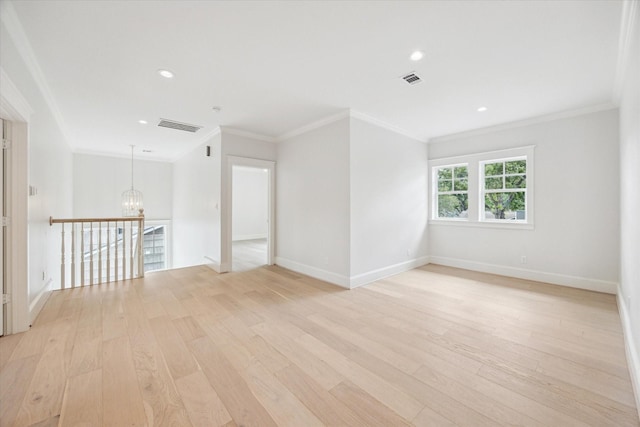 spare room with a chandelier, light wood-type flooring, baseboards, crown molding, and recessed lighting