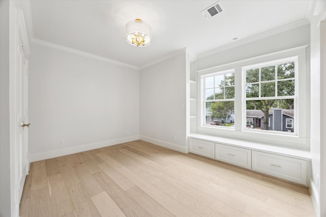 empty room with light wood-type flooring, crown molding, a chandelier, and baseboards