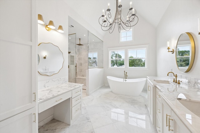 full bathroom with marble tiled flooring, a walk in shower, a chandelier, a freestanding tub, and double vanity
