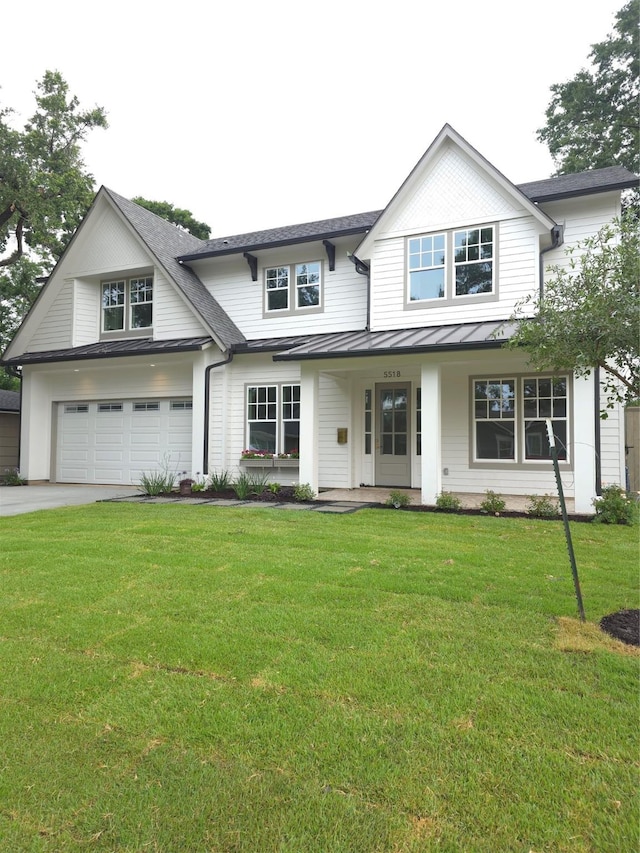 5518 Schumacher Ln, Houston, TX 77056 - view of front of home featuring a standing seam roof, driveway, a garage, a porch, and a front lawn