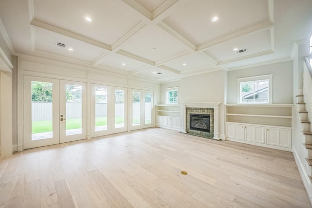 5518 Schumacher Ln, Houston, TX 77056 - unfurnished living room with coffered ceiling, light wood-type flooring, a tile fireplace, plenty of natural light, and beamed ceiling