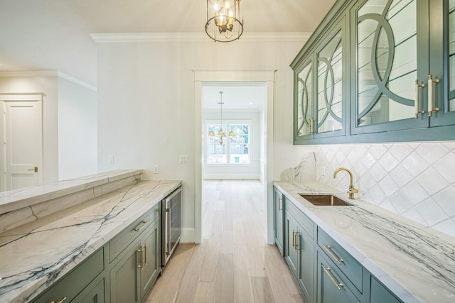 5518 Schumacher Ln, Houston, TX 77056 - kitchen featuring a chandelier, beverage cooler, green cabinetry, light wood-type flooring, and ornamental molding