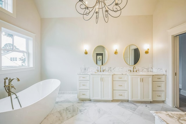 5518 Schumacher Ln, Houston, TX 77056 - bathroom featuring double vanity, a freestanding tub, a chandelier, high vaulted ceiling, and marble finish flooring