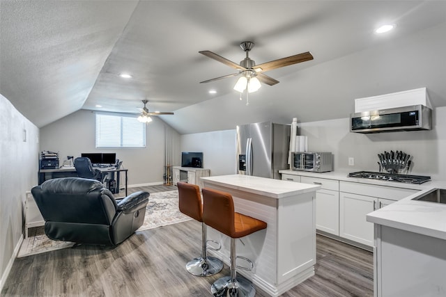 2017 Amado Ln, League City, TX 77573 - kitchen with appliances with stainless steel finishes, open floor plan, a desk, light countertops, and ceiling fan