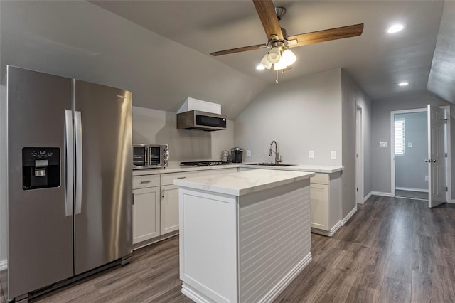 2017 Amado Ln, League City, TX 77573 - kitchen with appliances with stainless steel finishes, a sink, vaulted ceiling, white cabinets, and dark wood finished floors