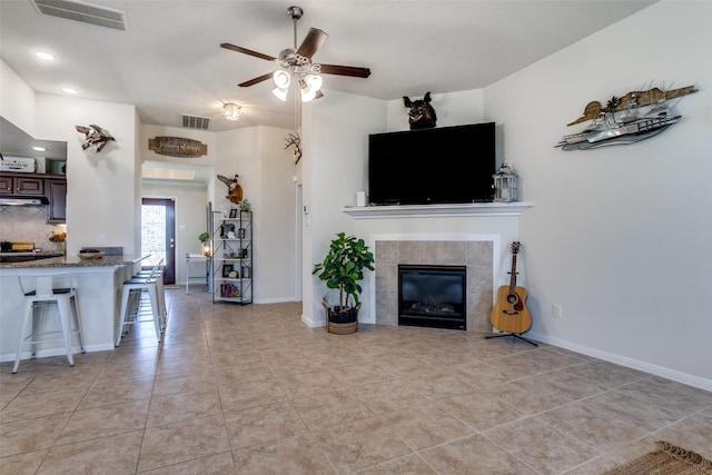 2017 Amado Ln, League City, TX 77573 - living room with a ceiling fan, a tiled fireplace, light tile patterned flooring, recessed lighting, and baseboards