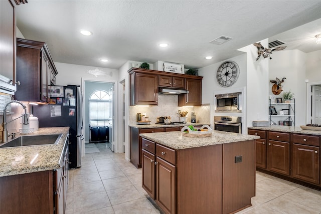 2017 Amado Ln, League City, TX 77573 - kitchen featuring a sink, stainless steel appliances, light tile patterned floors, backsplash, and recessed lighting