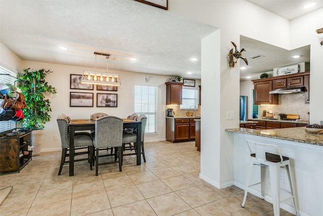 2017 Amado Ln, League City, TX 77573 - dining room featuring recessed lighting, light tile patterned flooring, a textured ceiling, and baseboards
