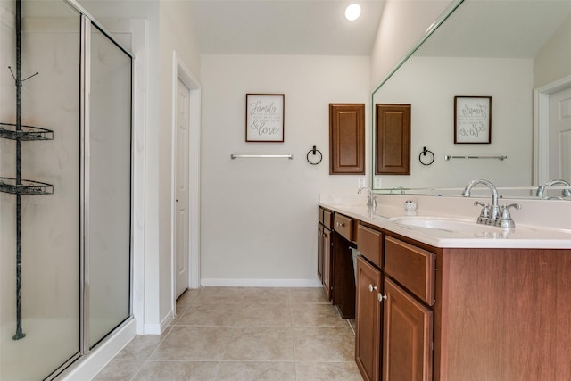 2017 Amado Ln, League City, TX 77573 - full bathroom featuring double vanity, a shower stall, tile patterned floors, and baseboards