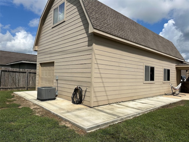 2017 Amado Ln, League City, TX 77573 - view of side of home featuring central AC, roof with shingles, and an attached garage