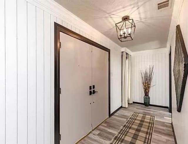 entryway with a chandelier and wood finished floors