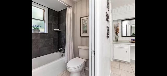 full bath featuring tile patterned flooring, toilet, shower / tub combo with curtain, and vanity