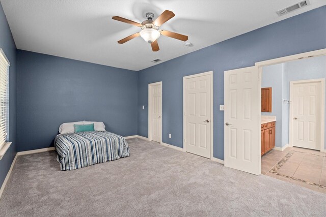 unfurnished bedroom with visible vents, baseboards, and light carpet