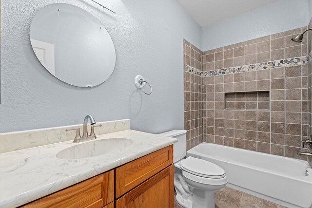 full bath with vanity, shower / bathing tub combination, a textured wall, and toilet