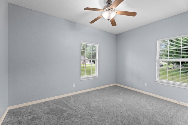spare room with carpet floors and baseboards