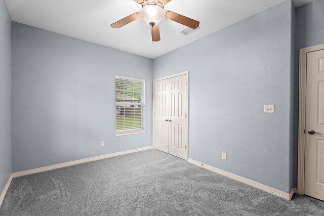 unfurnished bedroom featuring baseboards, visible vents, carpet, and a closet