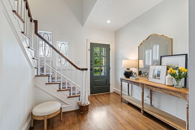 entryway featuring stairway, baseboards, recessed lighting, and wood finished floors