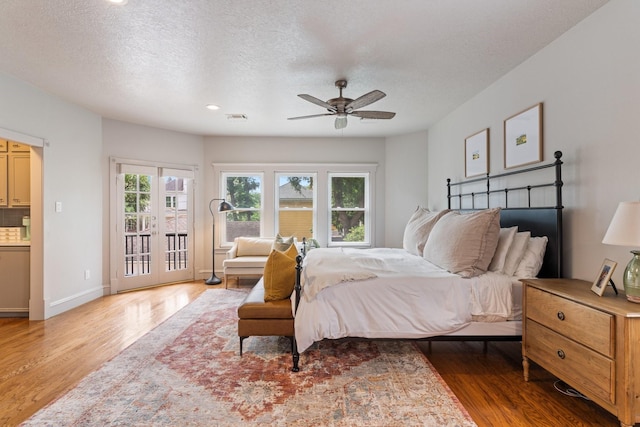 bedroom with access to outside, baseboards, ceiling fan, and wood finished floors