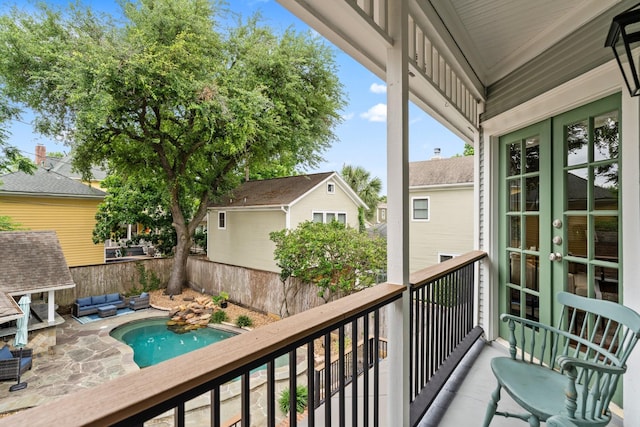 balcony featuring french doors, a patio, and an outdoor hangout area