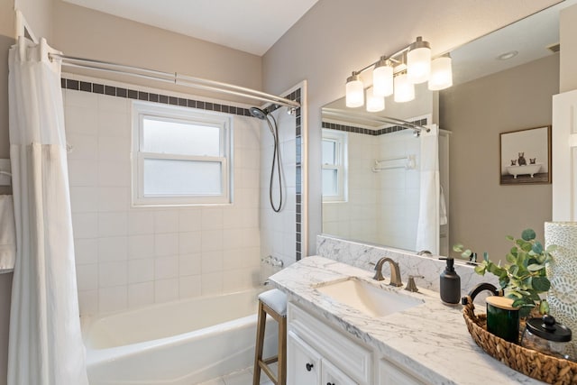 bathroom featuring vanity, shower / bath combo with shower curtain, and visible vents