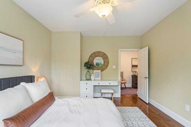 bedroom with a ceiling fan, baseboards, and dark wood-style floors