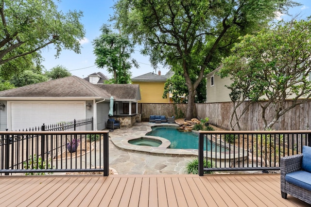 view of pool with a pool with connected hot tub, a wooden deck, a fenced backyard, and a patio area