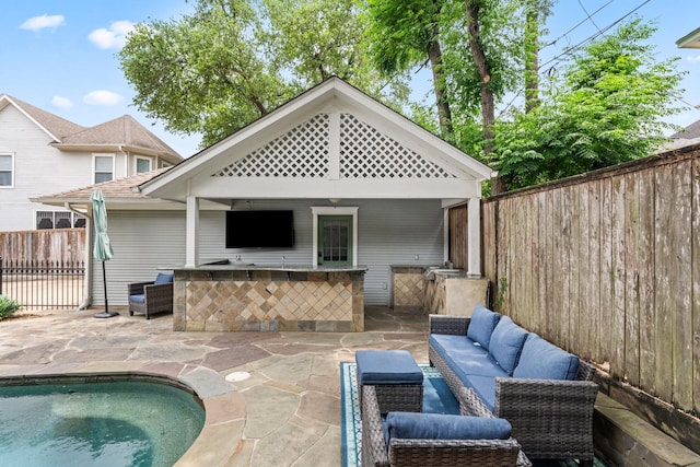 rear view of property with outdoor wet bar, a fenced in pool, an outdoor living space, a patio, and fence private yard