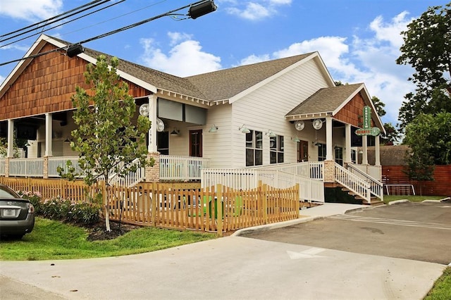 view of front of house featuring a porch and a shingled roof