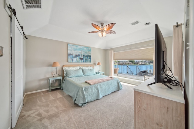 12858 Pelican Island Dr, Willis, TX 77318 - bedroom featuring light colored carpet, visible vents, a barn door, and access to exterior