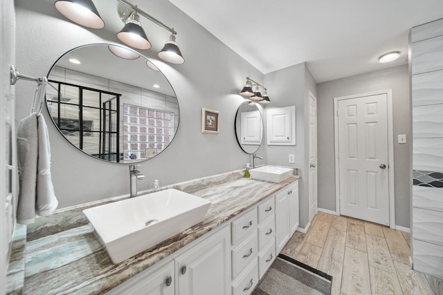 12858 Pelican Island Dr, Willis, TX 77318 - full bath with a sink, double vanity, and wood finished floors